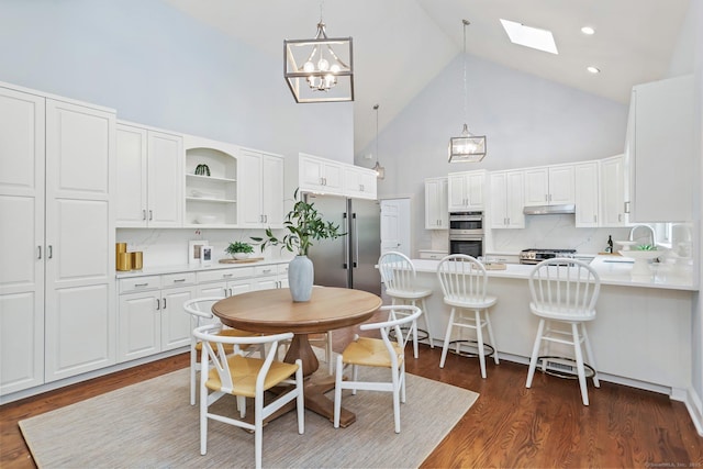 2787 Redding Rd, Fairfield, CT 06824 - dining space featuring high vaulted ceiling, a skylight, a chandelier, dark wood-style flooring, and recessed lighting