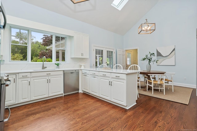 2787 Redding Rd, Fairfield, CT 06824 - kitchen with dishwasher, a peninsula, white cabinetry, a chandelier, and high vaulted ceiling