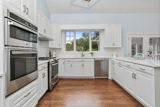 2787 Redding Rd, Fairfield, CT 06824 - kitchen with stainless steel appliances, white cabinetry, light countertops, tasteful backsplash, and dark wood finished floors