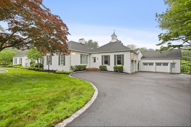 2787 Redding Rd, Fairfield, CT 06824 - view of front of house with driveway, a front yard, a shingled roof, an attached garage, and a chimney