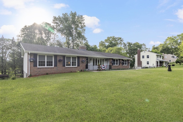 29 Birchwood Dr, Killingly, CT 06241 - single story home with brick siding, a chimney, a front lawn, and a porch