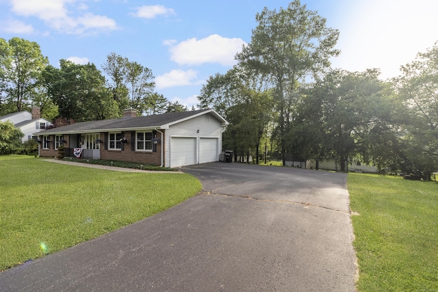 29 Birchwood Dr, Killingly, CT 06241 - single story home with driveway, brick siding, a garage, and a front lawn
