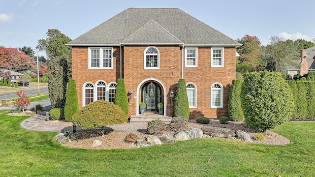 10 Amato Dr, Wethersfield, CT 06109 - colonial inspired home featuring a front lawn, brick siding, and roof with shingles