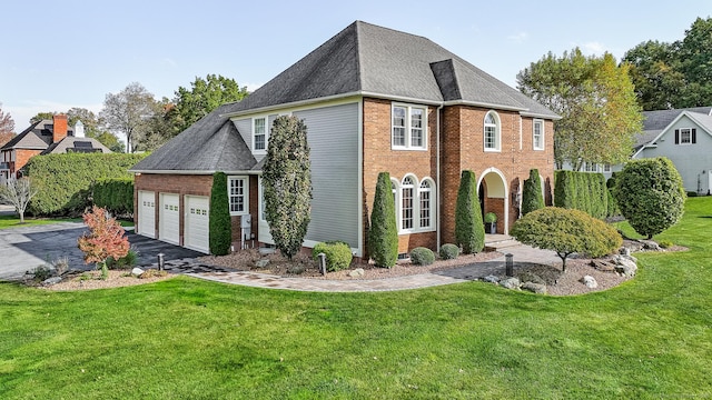 10 Amato Dr, Wethersfield, CT 06109 - view of front of house featuring a garage, brick siding, a front lawn, and driveway