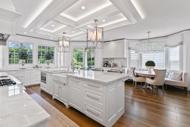 10 Amato Dr, Wethersfield, CT 06109 - kitchen featuring a chandelier, white cabinets, backsplash, light stone countertops, and dark wood-style floors