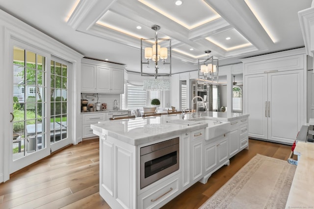 10 Amato Dr, Wethersfield, CT 06109 - kitchen with a chandelier, stainless steel microwave, white cabinets, plenty of natural light, and recessed lighting