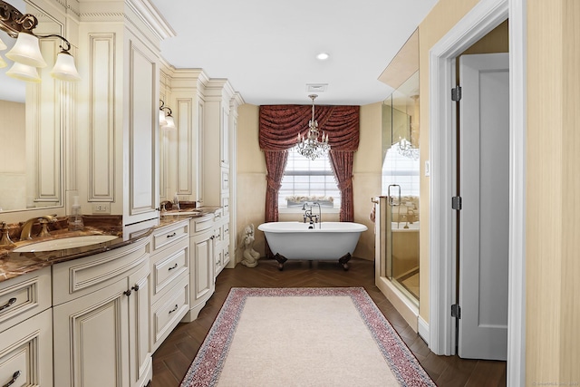 10 Amato Dr, Wethersfield, CT 06109 - bathroom with double vanity, a freestanding tub, a stall shower, and recessed lighting