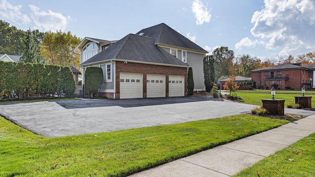 10 Amato Dr, Wethersfield, CT 06109 - view of property exterior featuring asphalt driveway, a garage, a lawn, brick siding, and roof with shingles