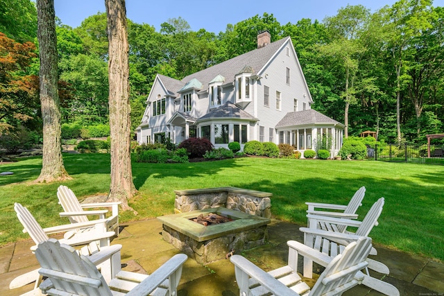 226 Nod Hill Rd, Wilton, CT 06897 - back of property with an outdoor fire pit, a chimney, a lawn, roof with shingles, and a patio