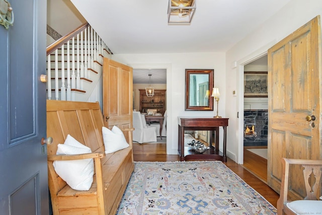 216 Hillspoint Rd, Westport, CT 06880 - foyer with wood finished floors, stairway, and a lit fireplace