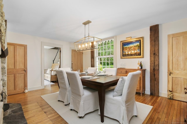 216 Hillspoint Rd, Westport, CT 06880 - dining space featuring light wood finished floors, a chandelier, and stairs