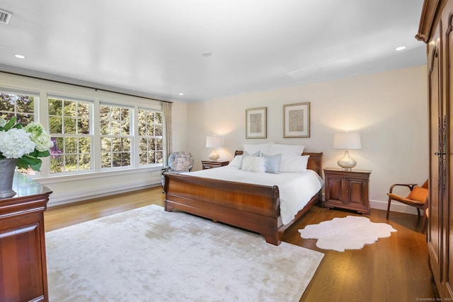 216 Hillspoint Rd, Westport, CT 06880 - bedroom with wood finished floors, baseboard heating, and recessed lighting