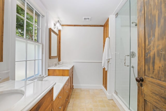216 Hillspoint Rd, Westport, CT 06880 - bathroom featuring double vanity, a shower stall, and a wainscoted wall