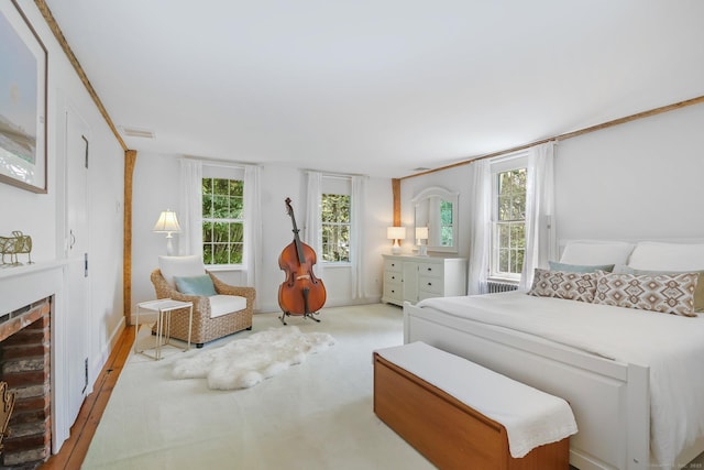 216 Hillspoint Rd, Westport, CT 06880 - bedroom with a brick fireplace, multiple windows, and carpet flooring