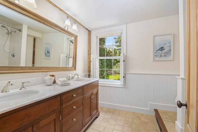 216 Hillspoint Rd, Westport, CT 06880 - full bathroom with double vanity, wainscoting, and a shower