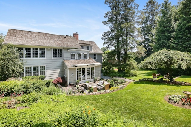 216 Hillspoint Rd, Westport, CT 06880 - back of property with a lawn, a chimney, a patio, french doors, and roof with shingles