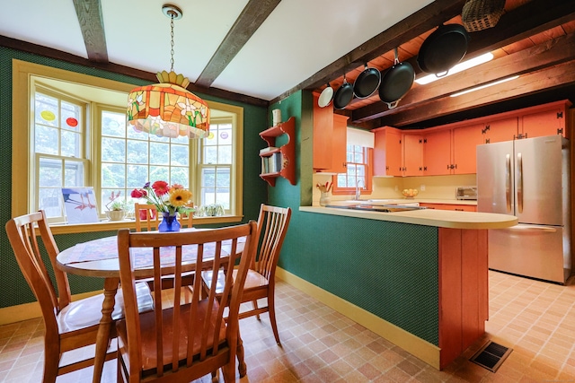 15 Harris Rd, Salem, CT 06420 - kitchen featuring freestanding refrigerator, beam ceiling, light countertops, hanging light fixtures, and a peninsula