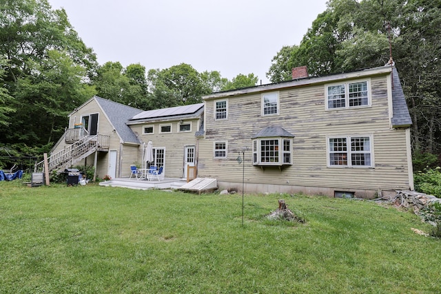 15 Harris Rd, Salem, CT 06420 - back of house with a chimney, a yard, stairway, solar panels, and a wooden deck