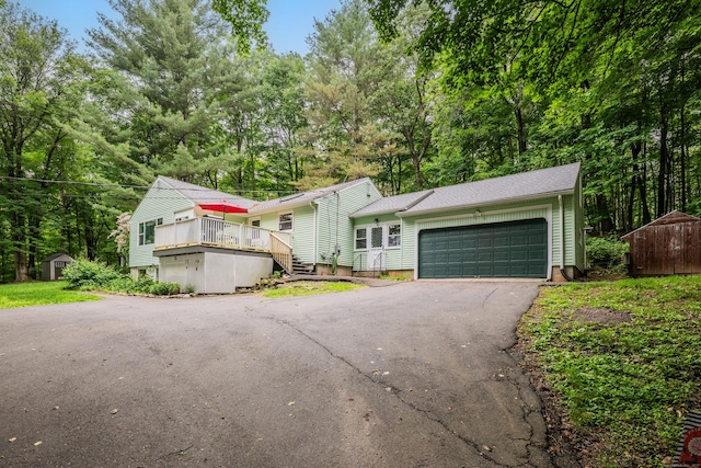 98 Torrington Ave, Canton, CT 06019 - view of front facade with a shed, asphalt driveway, a garage, a deck, and stairway