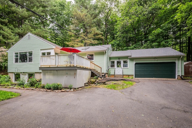 98 Torrington Ave, Canton, CT 06019 - view of front of property featuring asphalt driveway, an attached garage, a wooden deck, stairway, and view of wooded area