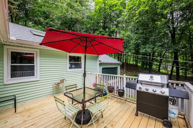 98 Torrington Ave, Canton, CT 06019 - wooden terrace featuring grilling area, outdoor dining space, a garage, and view of scattered trees
