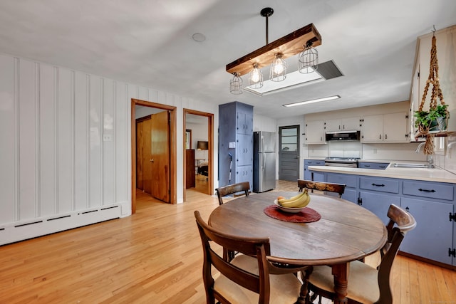 98 Torrington Ave, Canton, CT 06019 - dining area featuring light wood-style flooring and a baseboard radiator