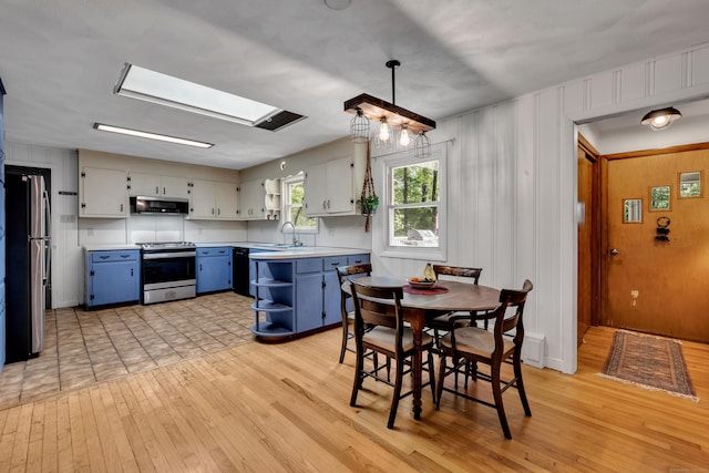 98 Torrington Ave, Canton, CT 06019 - kitchen with stainless steel appliances, blue cabinetry, extractor fan, open shelves, and light countertops