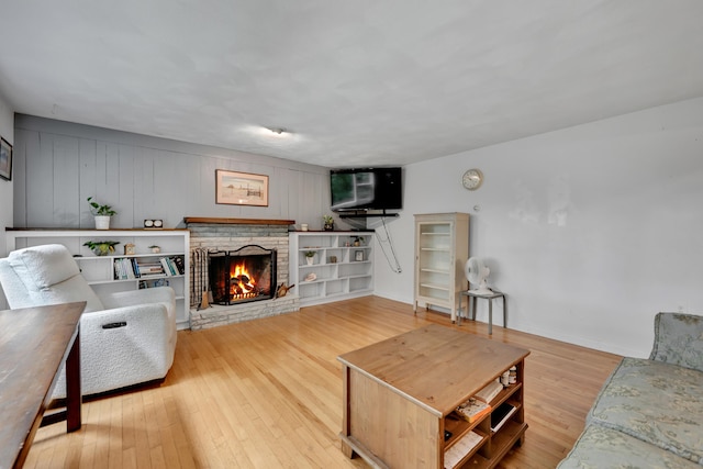 98 Torrington Ave, Canton, CT 06019 - living room featuring a warm lit fireplace and hardwood / wood-style floors