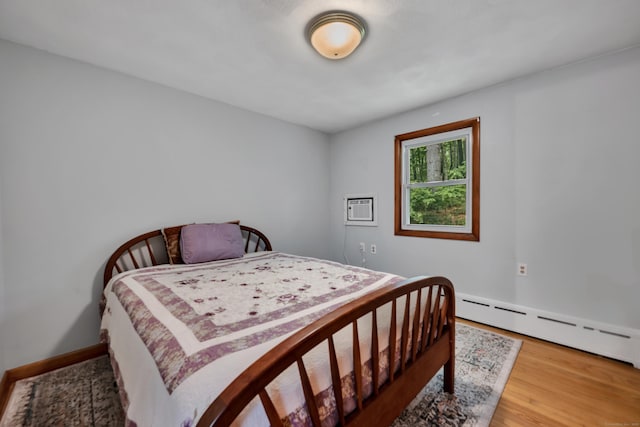 98 Torrington Ave, Canton, CT 06019 - bedroom with wood finished floors, baseboard heating, and a wall unit AC