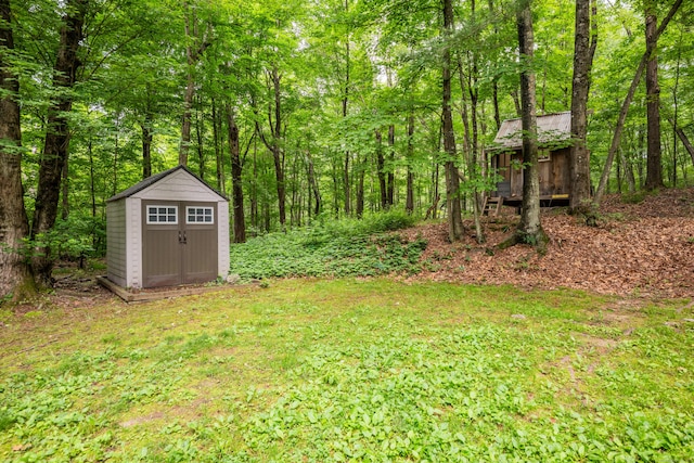 98 Torrington Ave, Canton, CT 06019 - view of yard featuring a storage shed and a wooded view