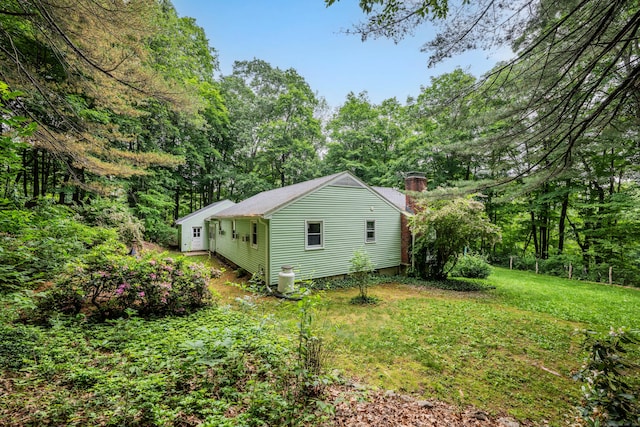98 Torrington Ave, Canton, CT 06019 - view of side of property featuring a chimney and a lawn