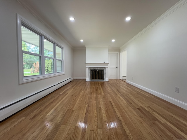 52 Sylvan St, Avon, CT 06001 - unfurnished living room with a baseboard heating unit, crown molding, wood finished floors, recessed lighting, and a glass covered fireplace