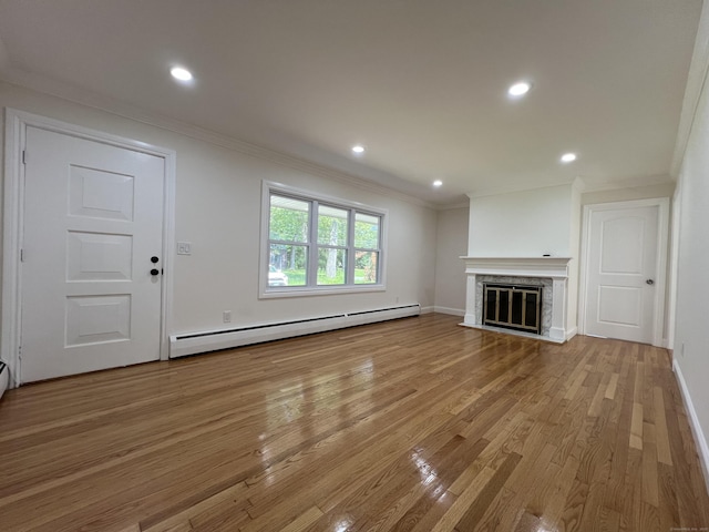 52 Sylvan St, Avon, CT 06001 - unfurnished living room with a baseboard heating unit, ornamental molding, light wood-type flooring, a glass covered fireplace, and recessed lighting