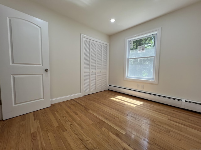 52 Sylvan St, Avon, CT 06001 - unfurnished bedroom with light wood-type flooring, a closet, recessed lighting, and baseboard heating