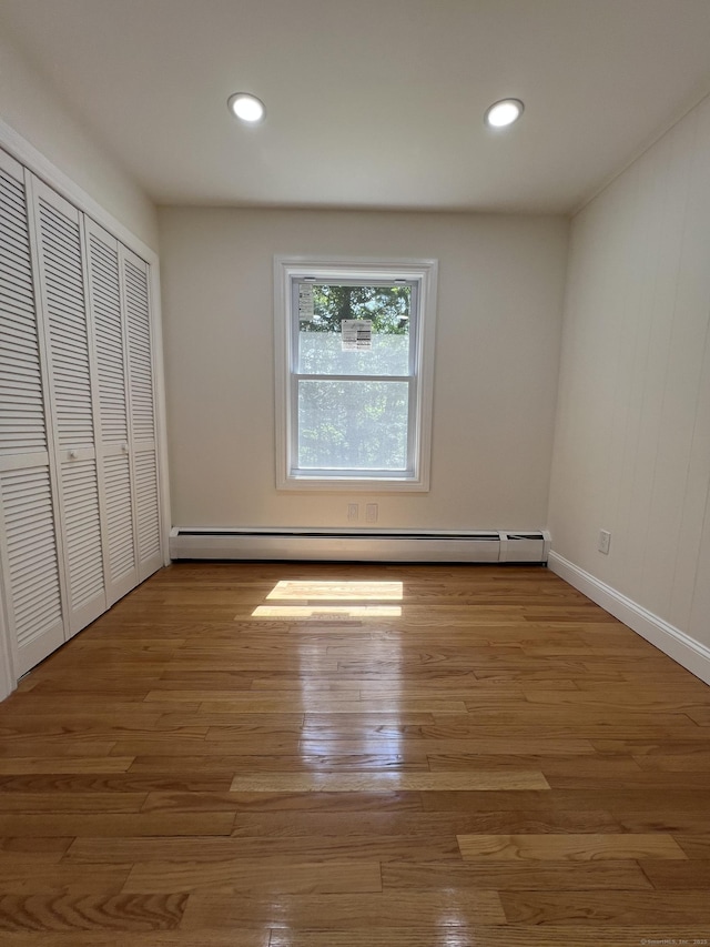 52 Sylvan St, Avon, CT 06001 - unfurnished bedroom featuring baseboard heating, wood finished floors, recessed lighting, and a closet