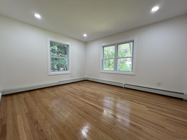 52 Sylvan St, Avon, CT 06001 - empty room with wood finished floors, recessed lighting, and baseboard heating