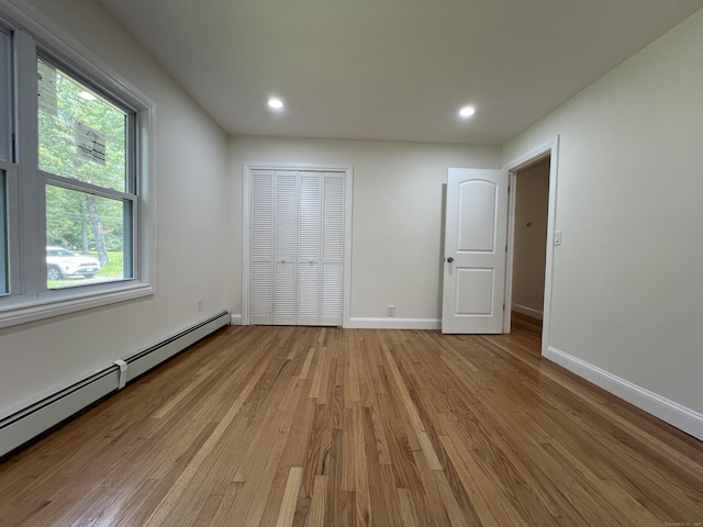 52 Sylvan St, Avon, CT 06001 - unfurnished bedroom featuring a baseboard radiator, light wood-type flooring, and recessed lighting