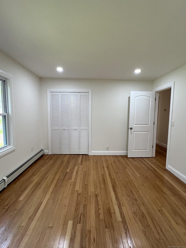 52 Sylvan St, Avon, CT 06001 - unfurnished bedroom with light wood-style floors, recessed lighting, baseboard heating, and a closet