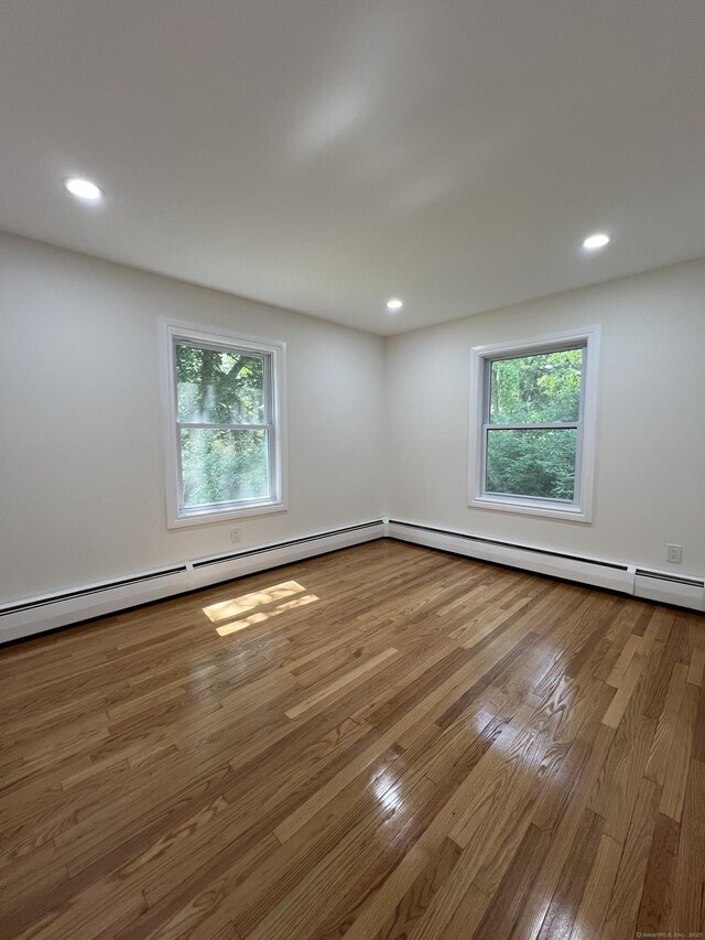 52 Sylvan St, Avon, CT 06001 - spare room featuring healthy amount of natural light, wood finished floors, recessed lighting, and a baseboard radiator