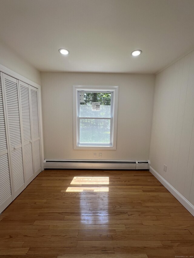52 Sylvan St, Avon, CT 06001 - unfurnished bedroom featuring baseboard heating, wood finished floors, recessed lighting, and a closet