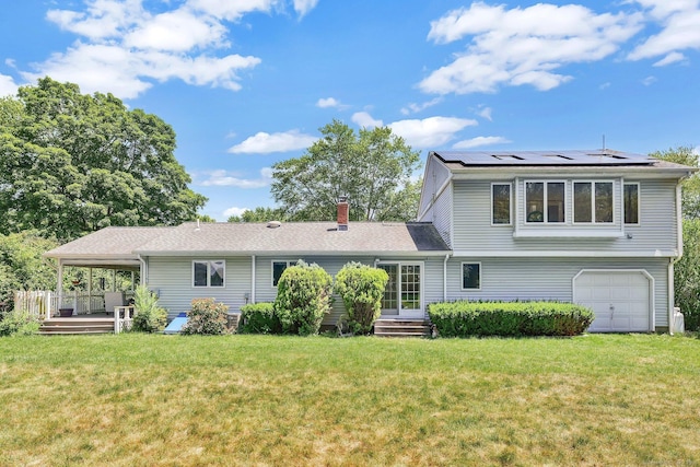 97 Benedict Dr, South Windsor, CT 06074 - view of front of house featuring a front yard, roof mounted solar panels, an attached garage, a chimney, and a wooden deck