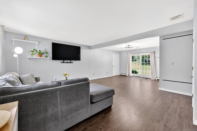 97 Benedict Dr, South Windsor, CT 06074 - living room with dark wood-style floors, a chandelier, and a baseboard radiator
