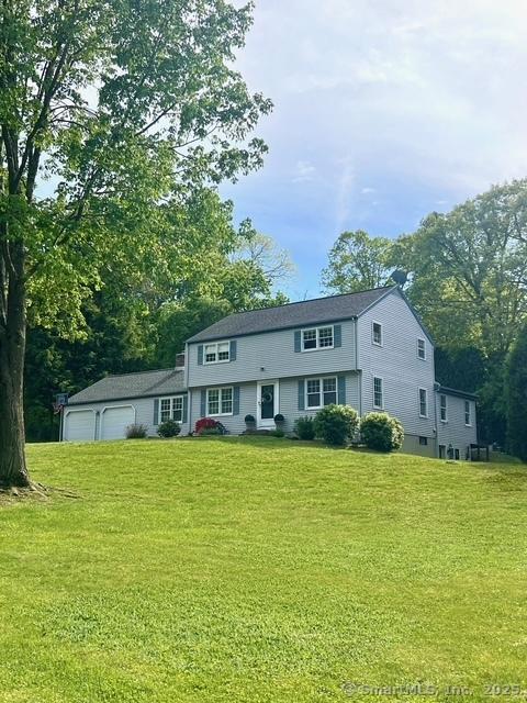 13 Charter Oak Dr, East Lyme, CT 06333 - view of front facade with a front lawn and an attached garage