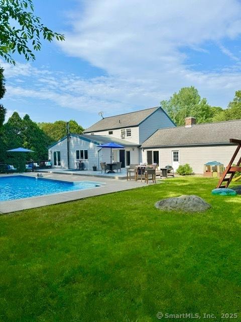 13 Charter Oak Dr, East Lyme, CT 06333 - back of house featuring a patio, an outdoor pool, and a lawn