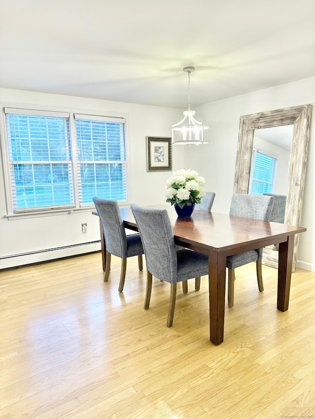 13 Charter Oak Dr, East Lyme, CT 06333 - dining area featuring a chandelier, light wood-style flooring, healthy amount of natural light, and a baseboard heating unit