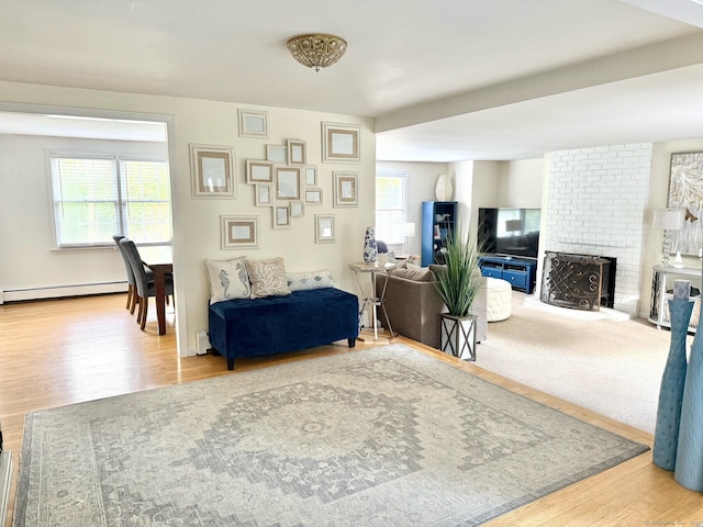 13 Charter Oak Dr, East Lyme, CT 06333 - living area featuring a baseboard heating unit, healthy amount of natural light, and wood finished floors