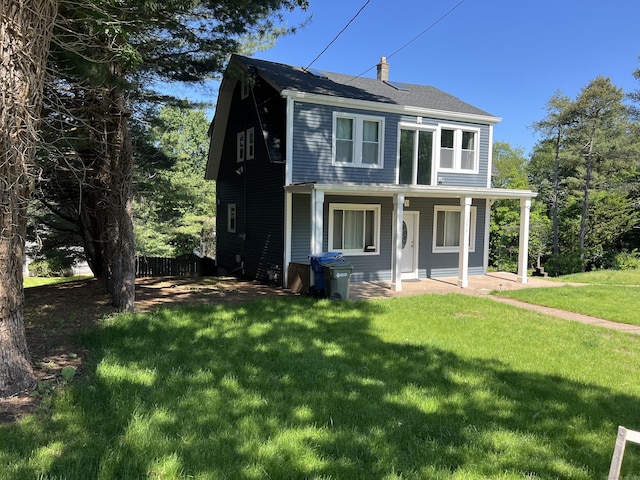 372 Oakland St, Manchester, CT 06042 - view of front of property with a chimney, a front yard, and covered porch