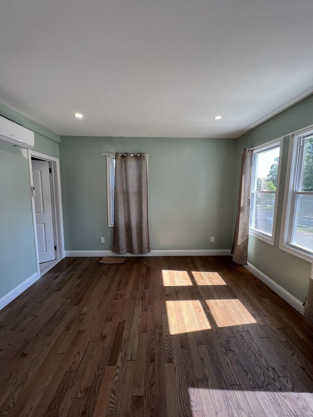 372 Oakland St, Manchester, CT 06042 - unfurnished room with dark wood-type flooring, a wall mounted AC, and recessed lighting