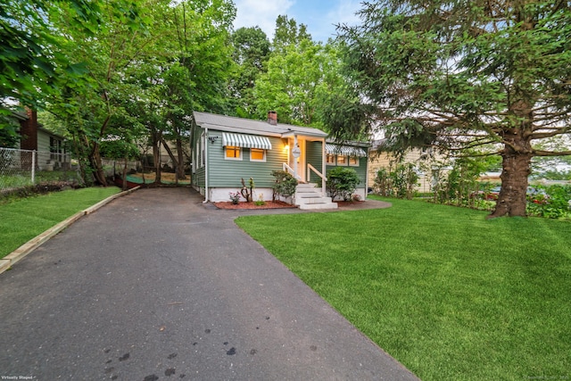 486 Barlow St, Bristol, CT 06010 - view of front facade featuring a chimney, asphalt driveway, and entry steps