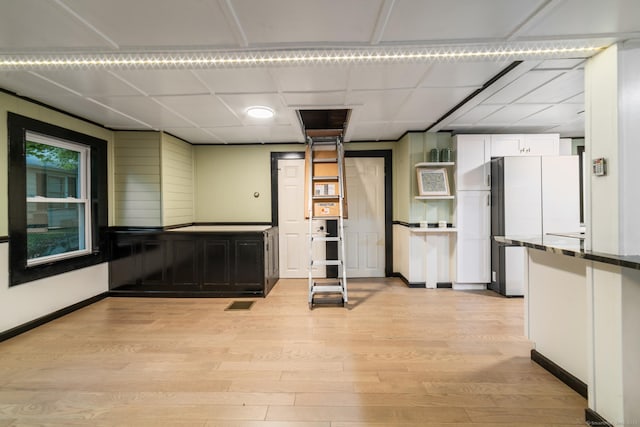 486 Barlow St, Bristol, CT 06010 - kitchen featuring light wood-style floors, white cabinetry, a paneled ceiling, and freestanding refrigerator